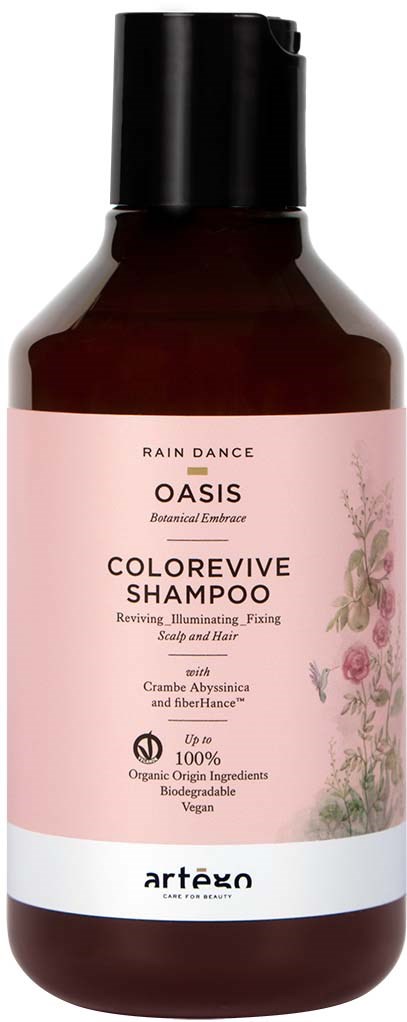 A bottle of Oasis ColorRevive Shampoo with pink label, plant illustrations, and product details like organic ingredients and vegan.