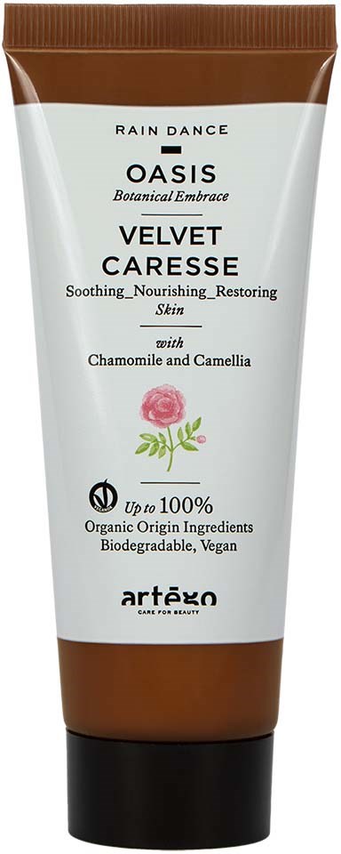 En vit och brun tub märkt Oasis Velvet Carese med blommönster, innehållande ekologisk, vegansk hudvård med kamomill och kamelia.