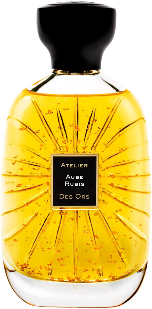 A perfume bottle with a black cap, golden liquid, and a black label with gold accents.