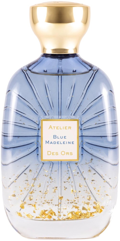 A perfume bottle with a gold cap, blue and clear glass, and a label that says 'Atelier Blue Madeleine Des Ors'.