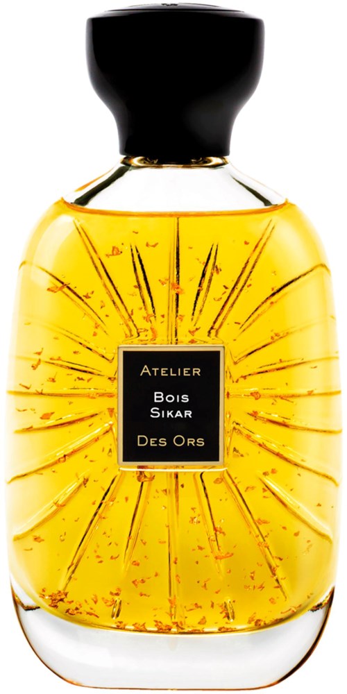 A perfume bottle with a black cap, filled with yellow liquid, and a label reading 'Atelier Bois Sikar Des Ors.'