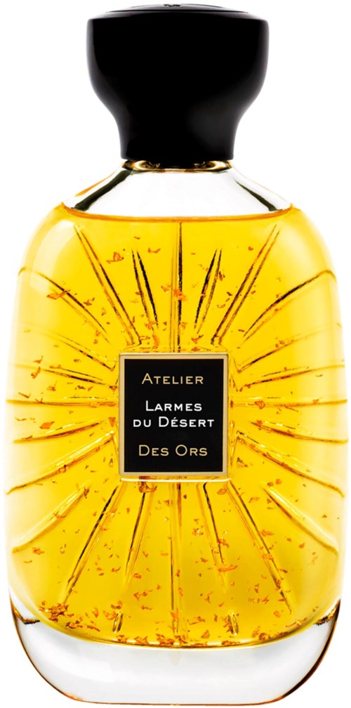 A perfume bottle with a black cap, glowing design, and the label 'Larmes du Désert' in black and gold.