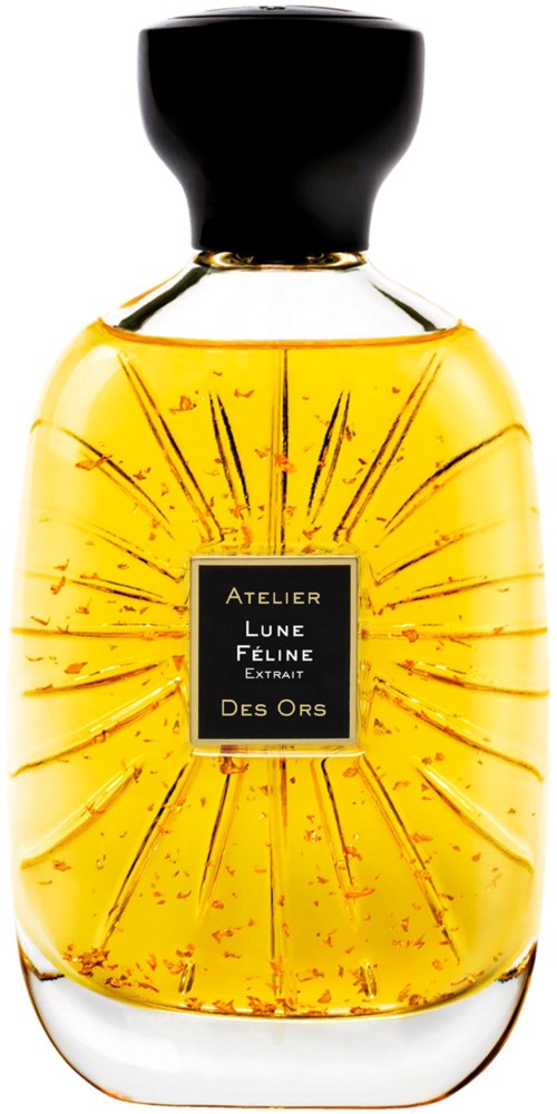 A yellow perfume bottle with a black cap, decorative lines, and a black label with gold text.