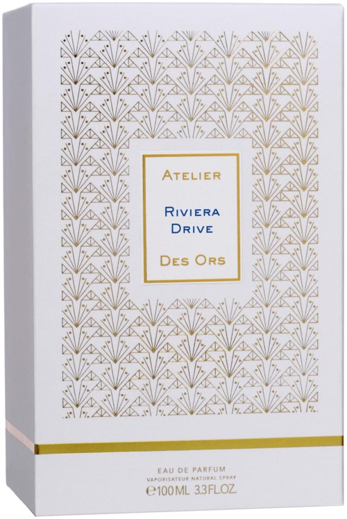 A perfume box with a white background, gold and blue text, and a decorative gold pattern.