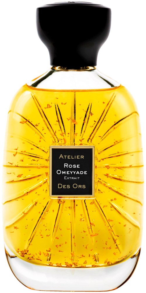 A perfume bottle with a black cap, filled with amber-colored liquid, and a label with gold text.