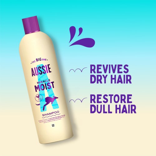 A shampoo bottle with purple cap, shows it helps revives dry hair and restores dull hair.