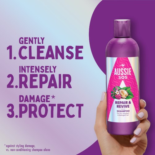 Shampoo bottle with label saying Aussie SOS. Text describes gentle cleansing, repair, and protection for hair.