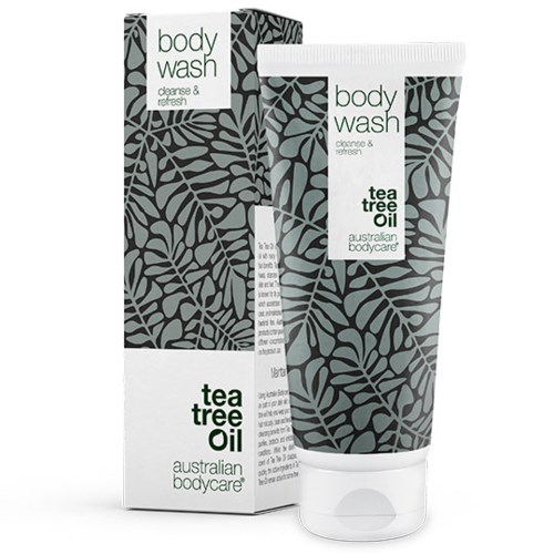 Eine Tube und eine Box Australian Body Care Teebaumöl Duschgel mit Blattmusterdesign.