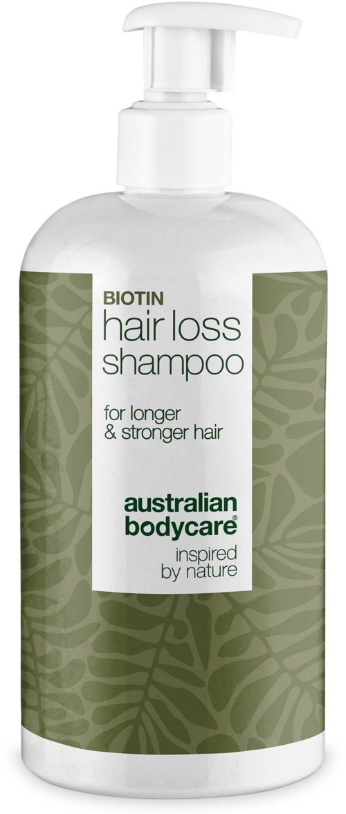 En hvit flaske med pumpe merket Biotin hårtap shampoo for sterkere hår, Australian Bodycare-merke, med grønt bladdesign.
