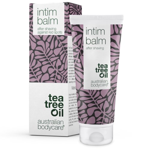 Eine Tube und eine Packung Aftershaving-Balm mit Teebaumöl. Die Verpackung hat ein lila und schwarzes Muster und grünen Text.