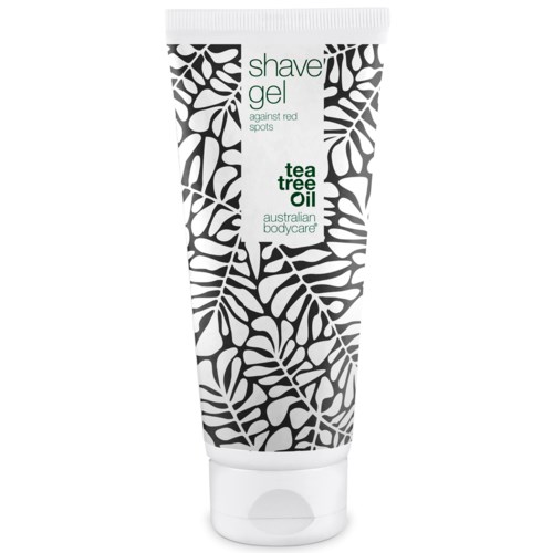 Een witte tube met zwarte bladpatronen, gelabeld 'shave gel' en 'tea tree oil' voor huidvlekken.