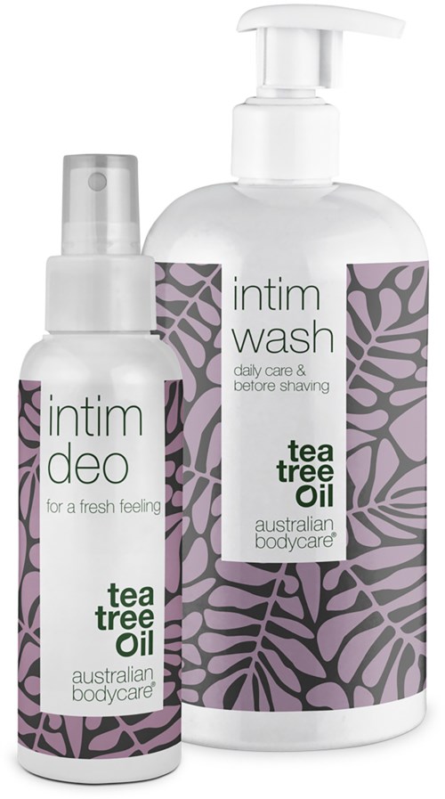 Two body care products with tea tree oil, one spray and one lotion bottle, decorated with purple and black leaf patterns.