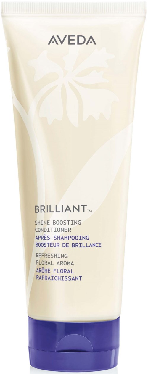 En hvit tube med Aveda Brilliant Shine Boosting Conditioner med lilla lokk og blomsterdesign på forsiden.