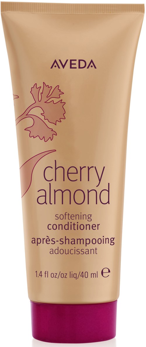 En mjukgörande balsam i en beige tub med lila och rosa detaljer, märkt 'Cherry Almond' av Aveda.