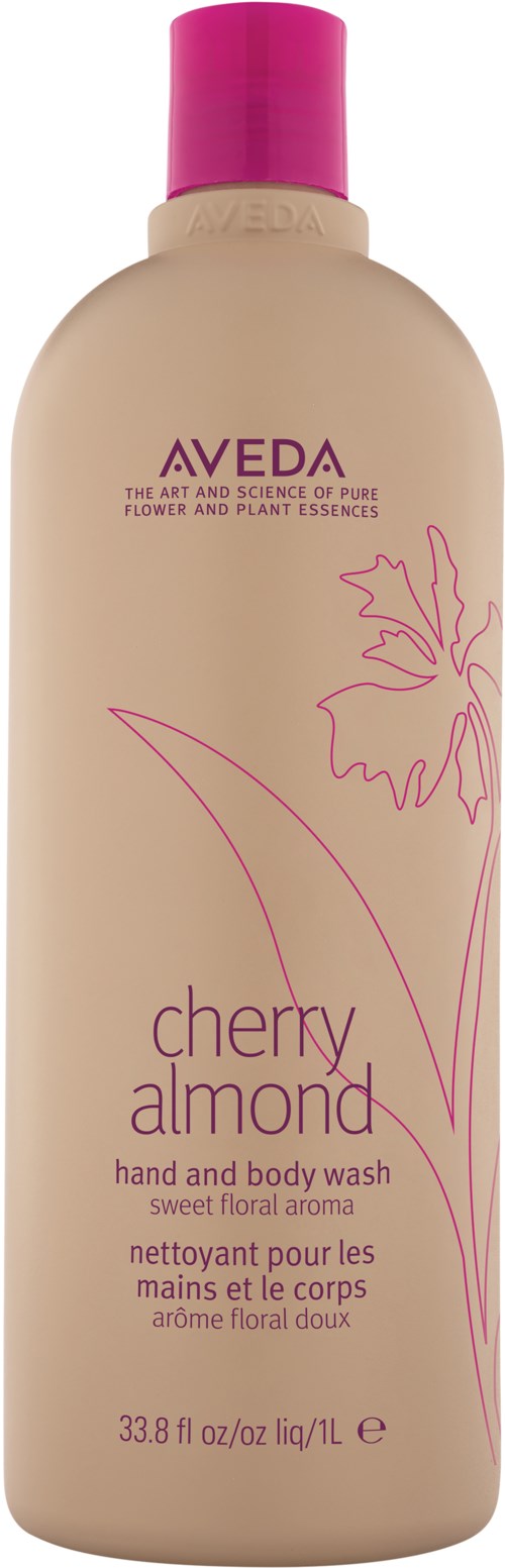 En beige flaska med rosa lock, etiketten säger Aveda Cherry Almond hand- och kroppstvål, blommig doft.