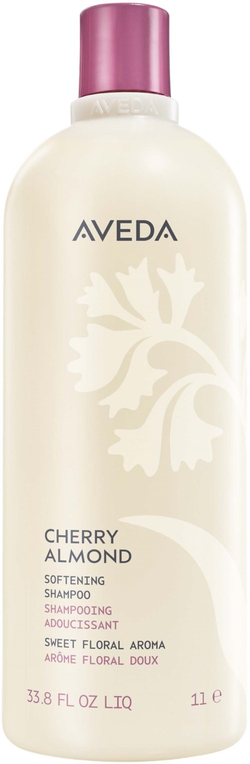 Eine weiße Shampooflasche mit pinkem Deckel, gekennzeichnet als Aveda Cherry Almond formendes Shampoo, blumiger Duft, 33,8 Unzen, 1 Liter.