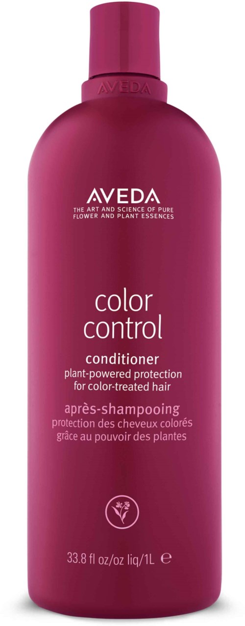 Eine Conditioner-Flasche ist pink mit weißen und lila Texten, für farbbehandeltes Haar.