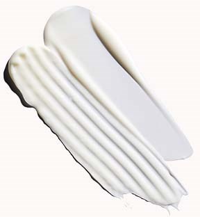 Two white spatulas, one with a flat blade and the other with a ridged edge, are laid flat.