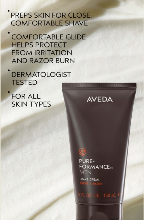 En tube med Aveda Pure-Performance Men barberkrem med produktdetaljer ved siden av på en lys stoffbakgrunn.