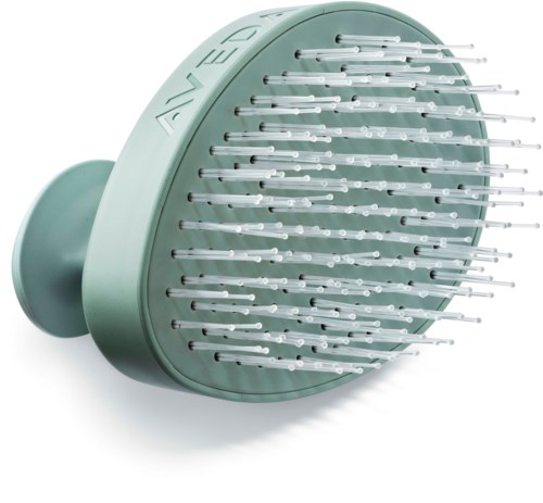 Ein grüner, runder Kopfhaut-Massagegerät mit vielen Metallnadeln zur Stimulation der Kopfhaut.