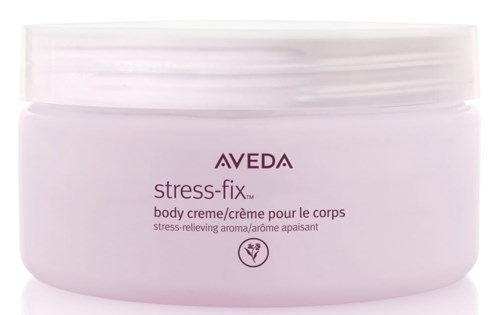 A soft pink body cream jar for stress relief from AVEDA, labeled as stress-fix, with a simple, calming design.