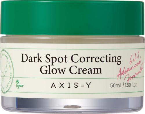 Een pot met donkere vlekken corrigerende glow-crème met een groene deksel en wit label. Het is veganistisch en 50 ml.