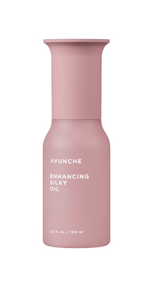 A pink bottle labeled 'Ayunche Enhancing Silky Oil', 100 ml capacity.