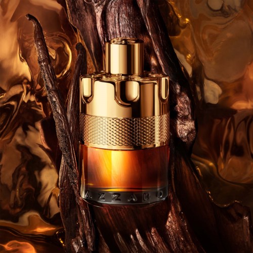 A luxurious perfume bottle with a gold cap, placed on dark, textured wood and golden backgrounds.