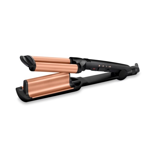 A rose gold curling iron with a black handle and digital controls. It is used to style hair.