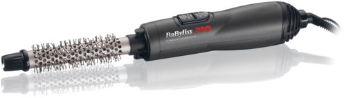 En svart hårtork med en rund borste fäst, märkt 'BaByliss 570', på en reflekterande yta.