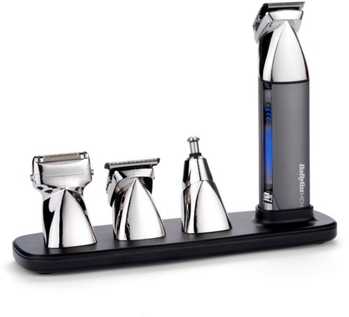 Four different shaver heads and a trimmer are placed on a black base, part of a grooming kit.