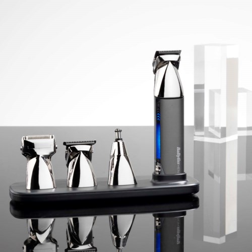 Four different electric shavers are placed on a black stand, with a plain white background.