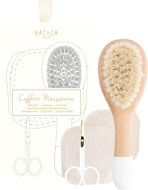 A cosmetic gift set includes a hairbrush, scissors, and cotton pads, presented with simple, elegant packaging.