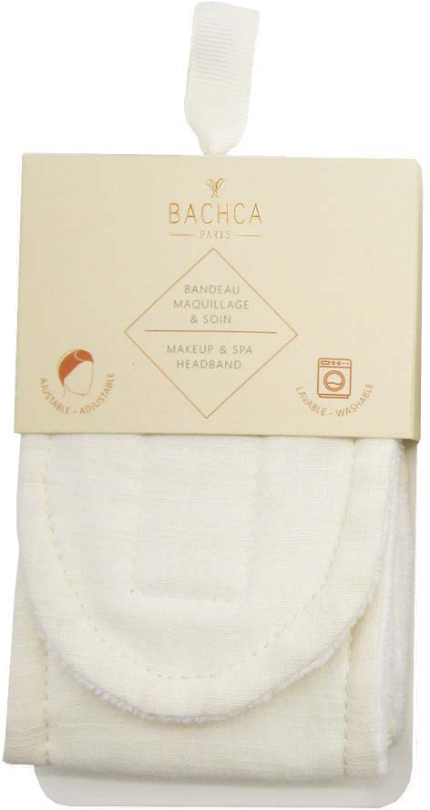 A white spa headband in packaging with gold text and symbols, including washing instructions.
