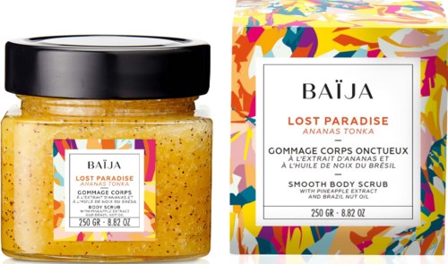 Yellow body scrub in a jar with colorful label and box, both have tropical and bright designs.