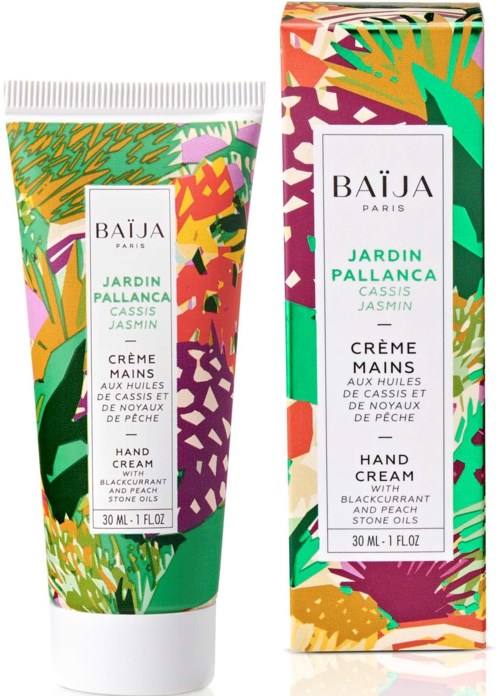 Colorful packaging for hand cream with floral and leaf designs, mentioning ingredients like cassis, jasmine, and peach.