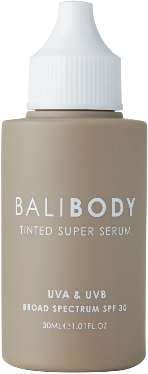 Beige fles met witte dop, labeled 'BALIBODY Tinted Super Serum' met SPF 30 bescherming.