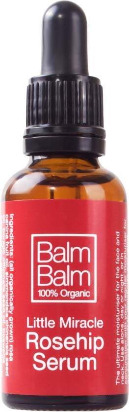 Kleine amberkleurige fles met pipetdop, gelabeld 'Balm Balm Little Miracle Rosehip Serum'.