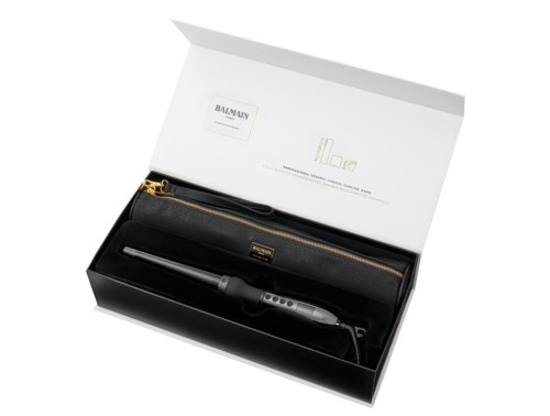 A black device in a box, with a long cord, a golden zipper case, and a small black box inside.