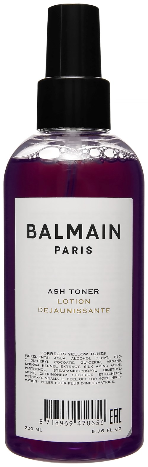 Violetti neste-kerrospullon mustalla suihkepäälä, merkinnällä Balmain Paris Ash Toner Lotion.