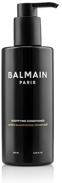 En svart flaska med pump, märkt Balmain Paris, innehållande kroppsslutföringsbalsam.