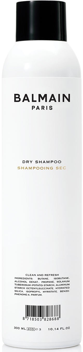 Pitkä valkoinen Balmain Paris kuiva shampoo -pullo mustalla kannella ja yksinkertaisella tekstillä.