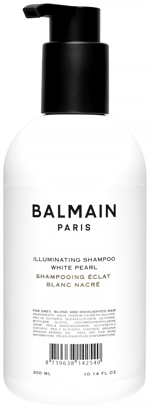 Valkoinen shampoopullo, jossa musta pumpunippa. Tunnisteessa on mustaa ja kultaisia tekstejä, mainiten Balmain Paris ja kirkastava shampoo.