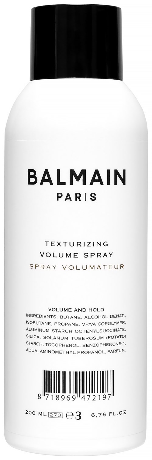 Valkoinen pullo mustalla päällä, merkitty 'Balmain Paris' hiusvolyymisuihkeeseen.