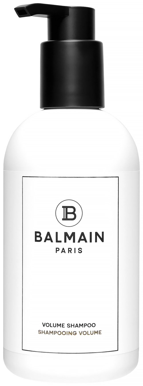 Valkoinen pullo, jossa on musta annostelija ja etiketti 'Balmain Paris Volume Shampoo'.