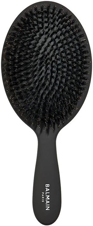 A black hairbrush with wide set bristles on an oval shape and a handle labeled 'Balmain Paris'.