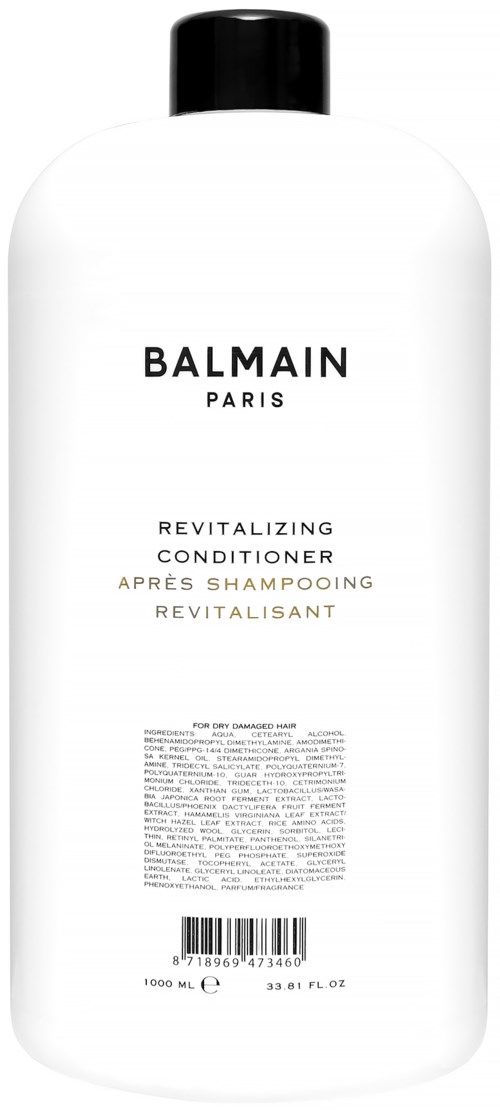 Valkoinen pullo Balmain Revitalizing Conditionerilla, musta kansi, etiketti mustana ja kullanvärisenä tekstinä, sekä viivakoodi.
