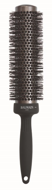 A black round hairbrush with a handle and metal bristles, labeled "Balmain" at the bottom.