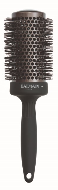 A black round hairbrush with a handle, metal bristles, and the brand name Balmain Paris on it.