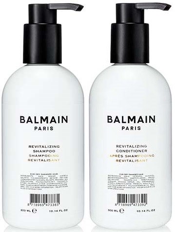 Kaksi valkoista pulloa mustilla pumppuilla, merkattu Balmain Paris, yksi shampoolle ja yksi hoitoaineelle.